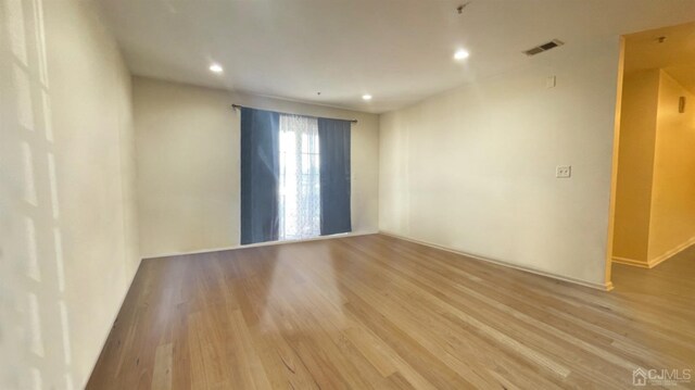 unfurnished room featuring light hardwood / wood-style floors