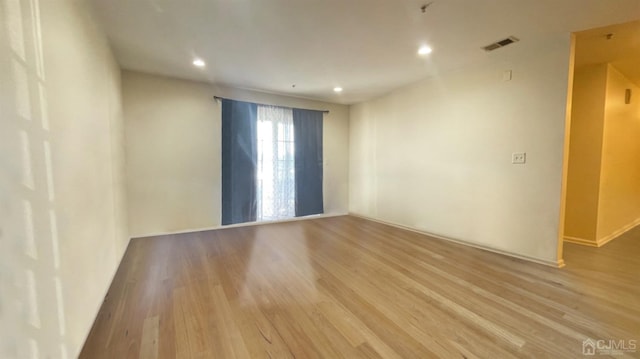 spare room with light wood-type flooring