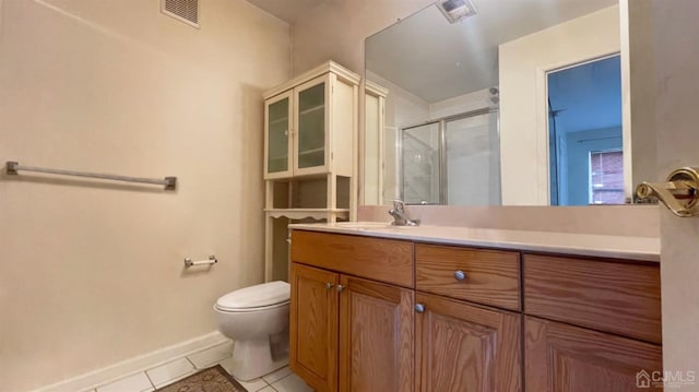 bathroom with vanity, tile patterned flooring, an enclosed shower, and toilet