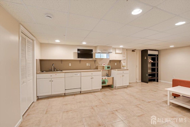 kitchen featuring white dishwasher, sink, a paneled ceiling, and extractor fan