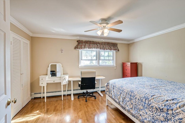 bedroom featuring hardwood / wood-style floors, ceiling fan, a closet, baseboard heating, and ornamental molding