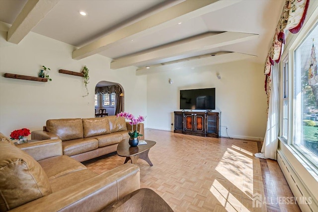 living room featuring light parquet floors and beamed ceiling