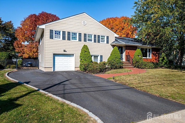 view of front of property featuring a front lawn and a garage