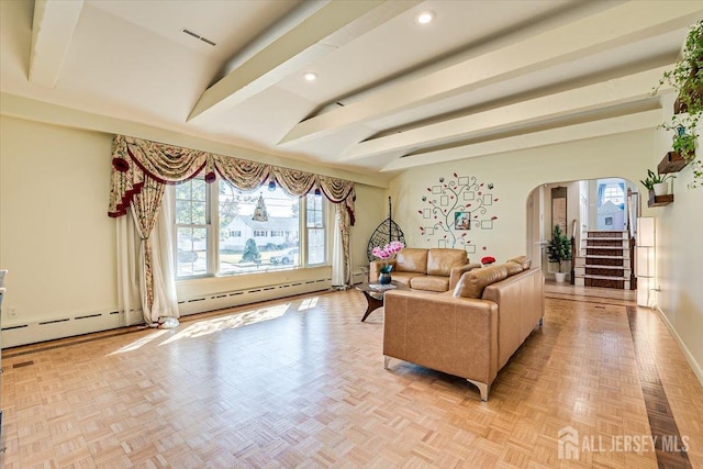 living room featuring beamed ceiling, light parquet flooring, and a baseboard heating unit