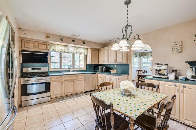 kitchen featuring sink, hanging light fixtures, stainless steel appliances, a healthy amount of sunlight, and light brown cabinets