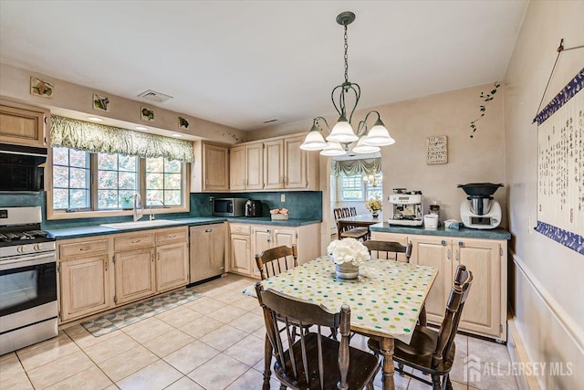 kitchen featuring sink, appliances with stainless steel finishes, hanging light fixtures, plenty of natural light, and light brown cabinetry