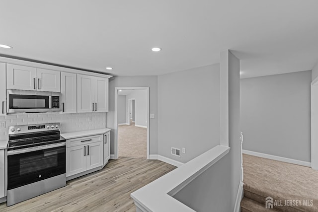 3 Bristol Ct Unit D, Monroe, NJ 08831 - kitchen with appliances with stainless steel finishes, light countertops, recessed lighting, decorative backsplash, and baseboards
