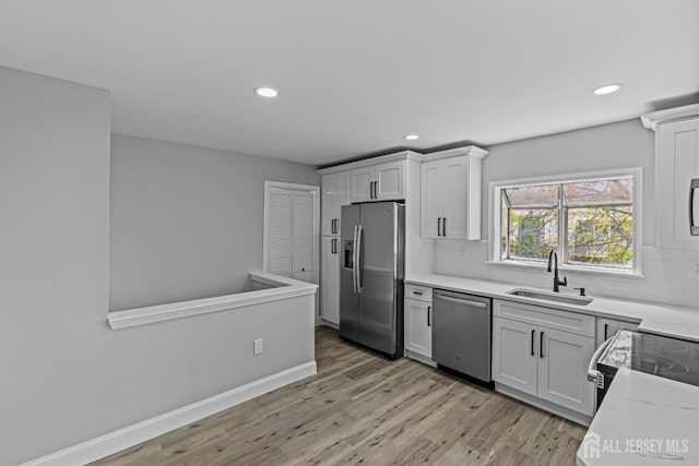 3 Bristol Ct Unit D, Monroe, NJ 08831 - kitchen with stainless steel appliances, a sink, recessed lighting, light wood-style flooring, and decorative backsplash