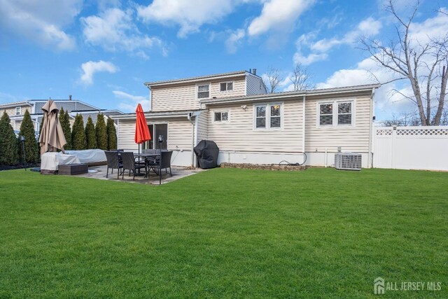 back of property featuring a yard, central AC, and a patio