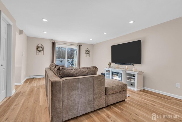 living room with light hardwood / wood-style flooring and baseboard heating