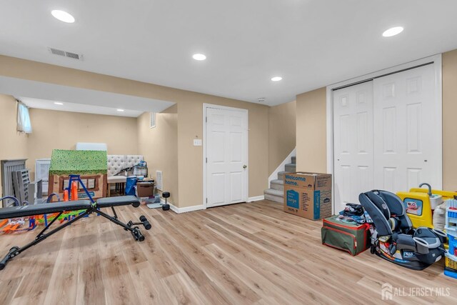 workout room featuring light hardwood / wood-style flooring