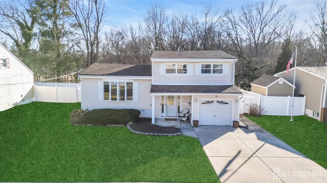 view of front of home featuring a garage and a front lawn