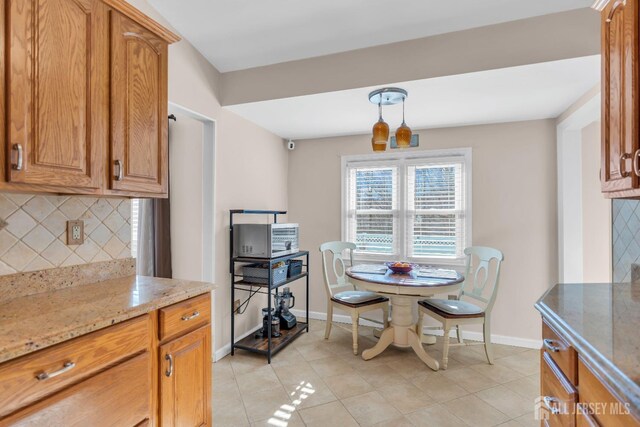 dining space featuring light tile patterned flooring