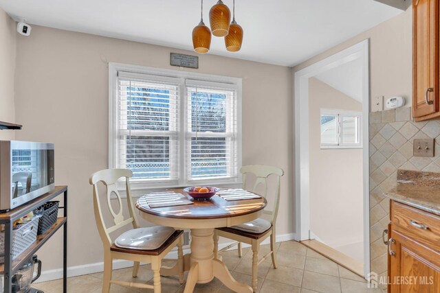 dining room with light tile patterned flooring