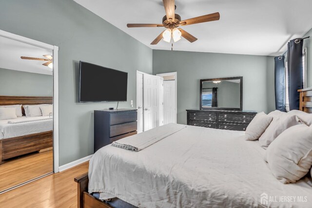 bedroom featuring wood-type flooring, ceiling fan, and vaulted ceiling