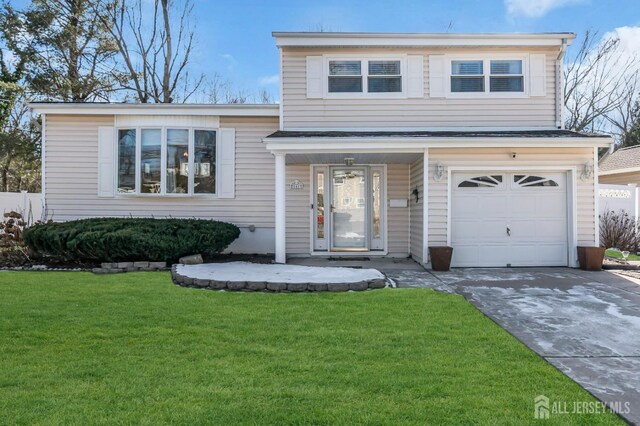 tri-level home featuring a garage and a front yard