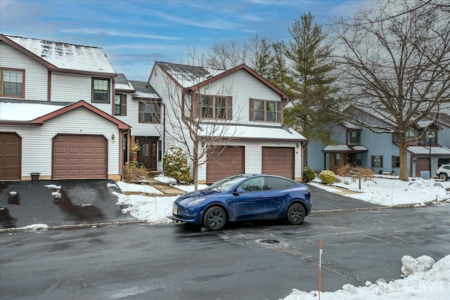 townhome / multi-family property featuring a garage and driveway