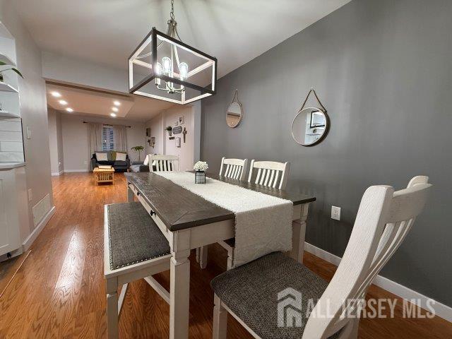 13 Heritage Ln, Fords, NJ 08863 - dining space with wood finished floors, a chandelier, and baseboards
