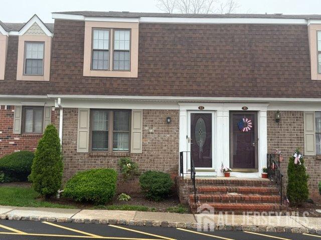 13 Heritage Ln, Fords, NJ 08863 - multi unit property featuring roof with shingles, mansard roof, uncovered parking, and brick siding
