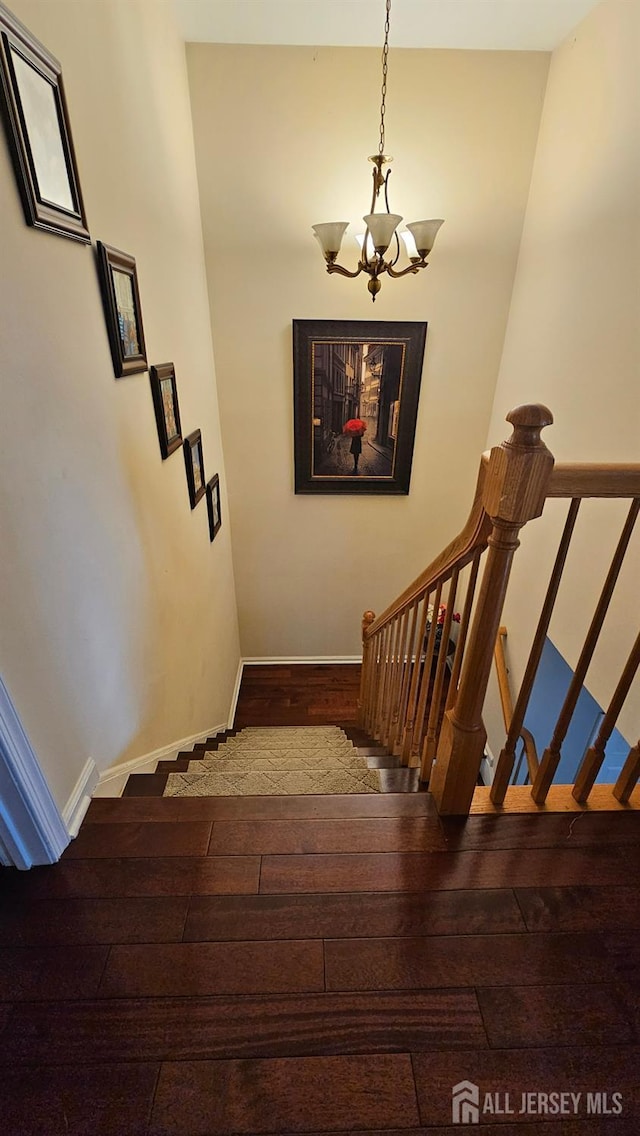 76 Tennyson Rd, East Windsor, NJ 08520 - stairway with a chandelier and wood finished floors