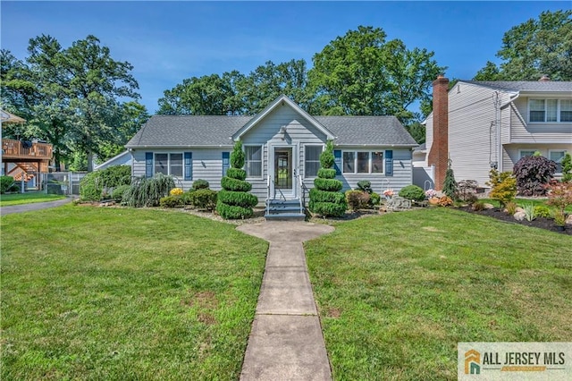 706 Wood Ave, North Brunswick, NJ 08902 - view of front of house featuring a front yard and a shingled roof