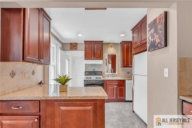 706 Wood Ave, North Brunswick, NJ 08902 - kitchen with white appliances, under cabinet range hood, backsplash, a peninsula, and light stone countertops