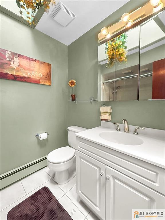 706 Wood Ave, North Brunswick, NJ 08902 - bathroom featuring tile patterned floors, a baseboard radiator, and vanity