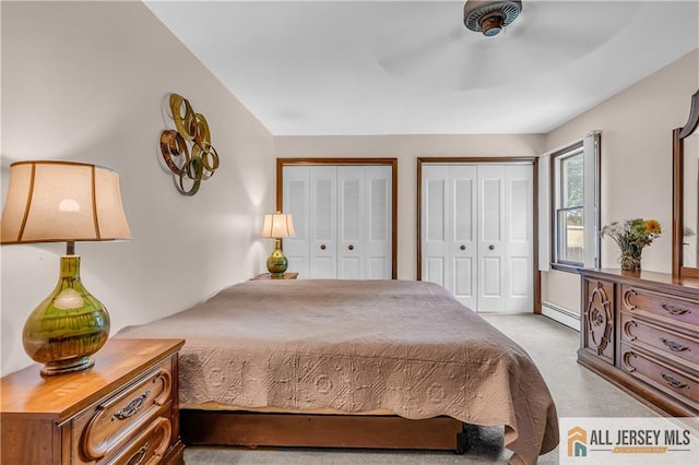 706 Wood Ave, North Brunswick, NJ 08902 - bedroom with baseboard heating, two closets, carpet floors, and a ceiling fan