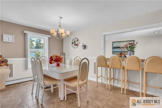 706 Wood Ave, North Brunswick, NJ 08902 - dining room with a baseboard radiator, a chandelier, light tile patterned floors, and a wainscoted wall