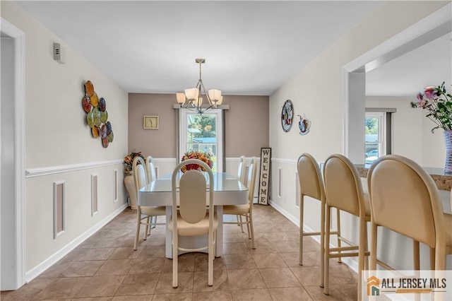 706 Wood Ave, North Brunswick, NJ 08902 - dining space with a chandelier and light tile patterned flooring