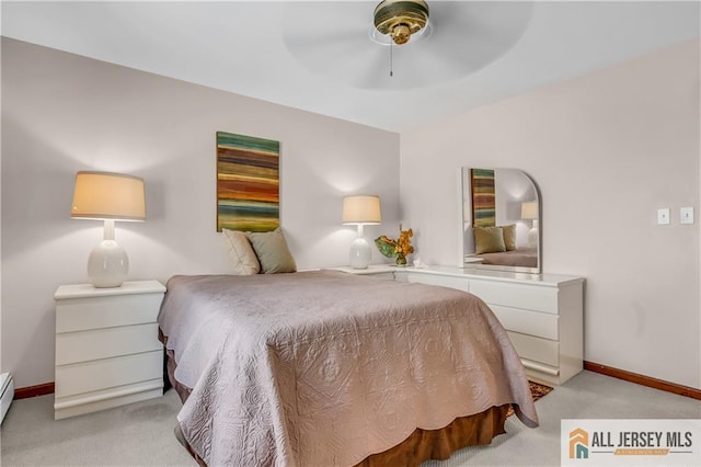 706 Wood Ave, North Brunswick, NJ 08902 - bedroom with light carpet, baseboard heating, and a ceiling fan