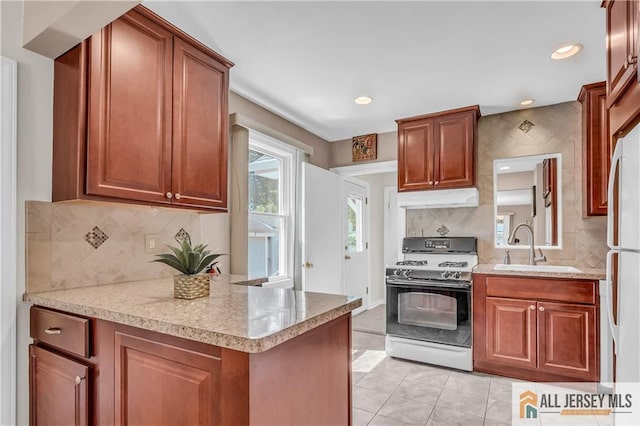 706 Wood Ave, North Brunswick, NJ 08902 - kitchen featuring white appliances, under cabinet range hood, tasteful backsplash, recessed lighting, and light tile patterned flooring