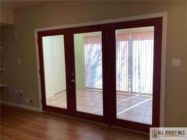 doorway to outside featuring light hardwood / wood-style floors and french doors