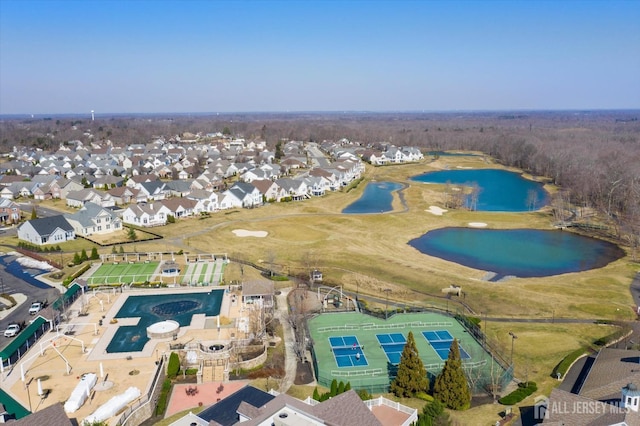 view of property location with a large body of water and nearby suburban area