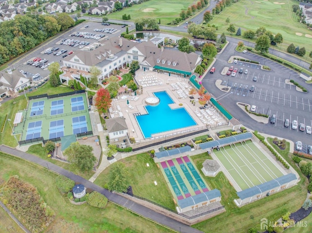 aerial view of property's location featuring a local golf course and a pool area