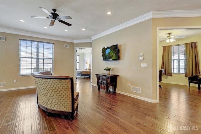 living room featuring ceiling fan, wood finished floors, healthy amount of natural light, ornamental molding, and recessed lighting