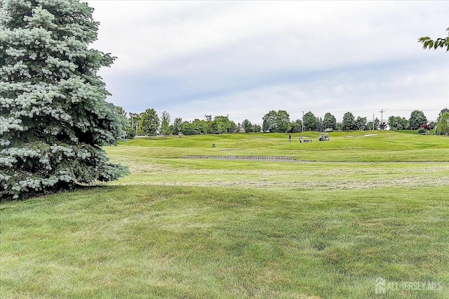 view of home's community with a yard and golf course view