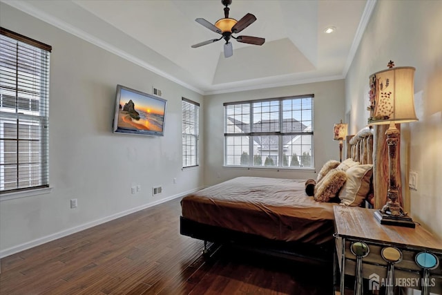 bedroom featuring a raised ceiling, wood finished floors, baseboards, ornamental molding, and ceiling fan