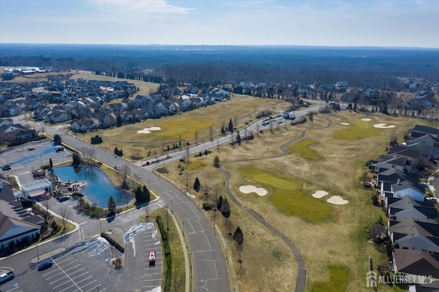 view of property location featuring a local golf course and nearby suburban area