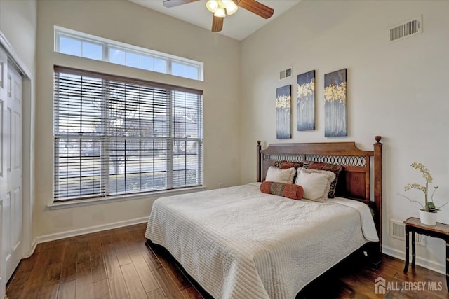bedroom featuring wood finished floors, baseboards, a closet, and a ceiling fan