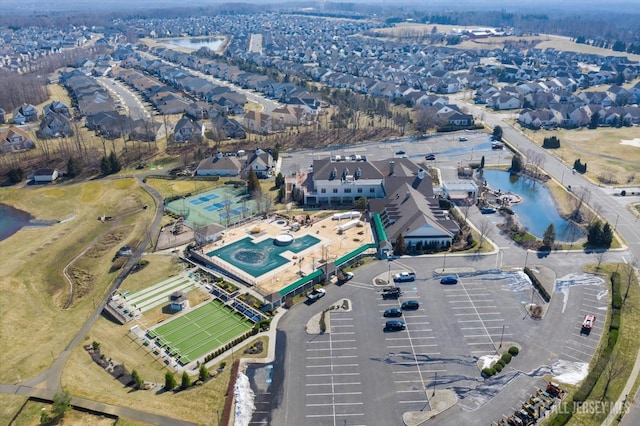 aerial overview of property's location with a large body of water and nearby suburban area