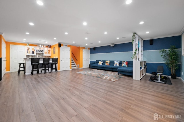 31 Morris Ln, Cranbury, NJ 08512 - living area with recessed lighting, bar with sink, stairs, ornamental molding, and light wood finished floors