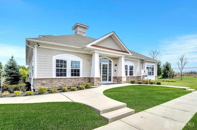 31 Morris Ln, Cranbury, NJ 08512 - view of front facade with a front lawn, stone siding, and french doors