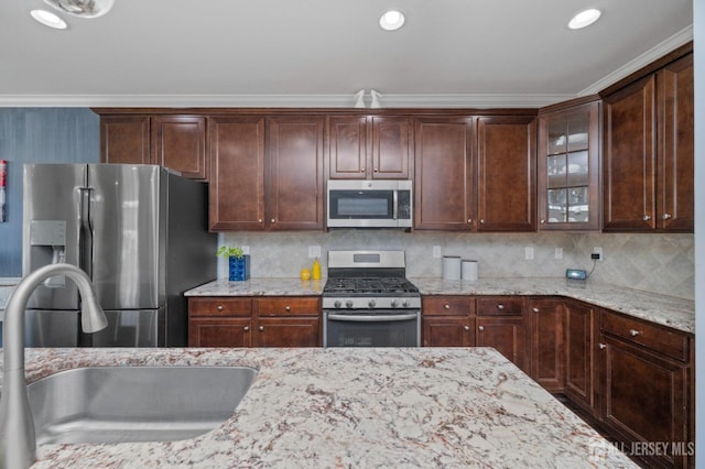 31 Morris Ln, Cranbury, NJ 08512 - kitchen with appliances with stainless steel finishes, a sink, glass insert cabinets, light stone counters, and ornamental molding