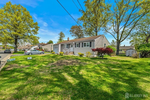 ranch-style home featuring a storage unit, a front lawn, an outbuilding, and a chimney