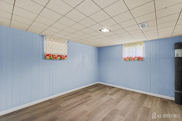 below grade area featuring wood finished floors and baseboards