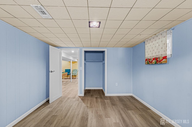 finished basement featuring wood finished floors and baseboards