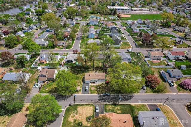 aerial view of property and surrounding area with nearby suburban area