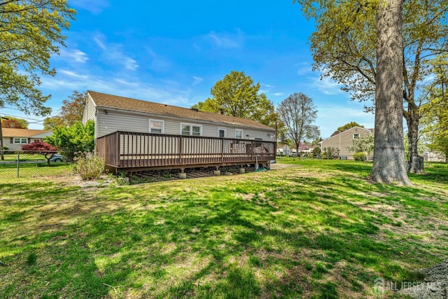 rear view of house featuring a wooden deck