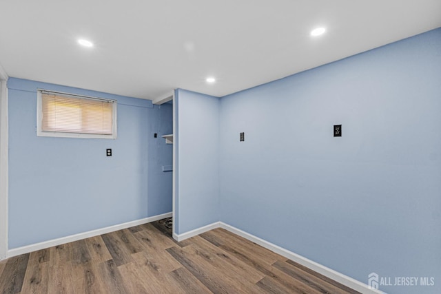 laundry area featuring wood finished floors, recessed lighting, and baseboards
